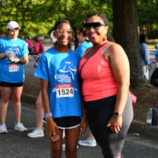 Girls on the Run participant with running buddy at 5K  